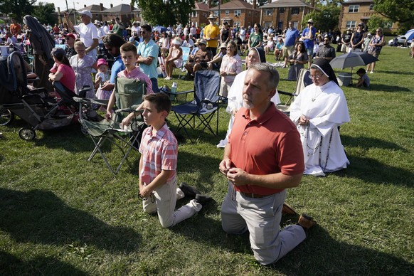 Attendees pray during a &quot;rosary rally&quot; on Sunday, Aug. 6, 2023, in Norwood, Ohio. A national religious organization, Catholics for Catholics, gathered a lineup of anti-abortion influencers a ...