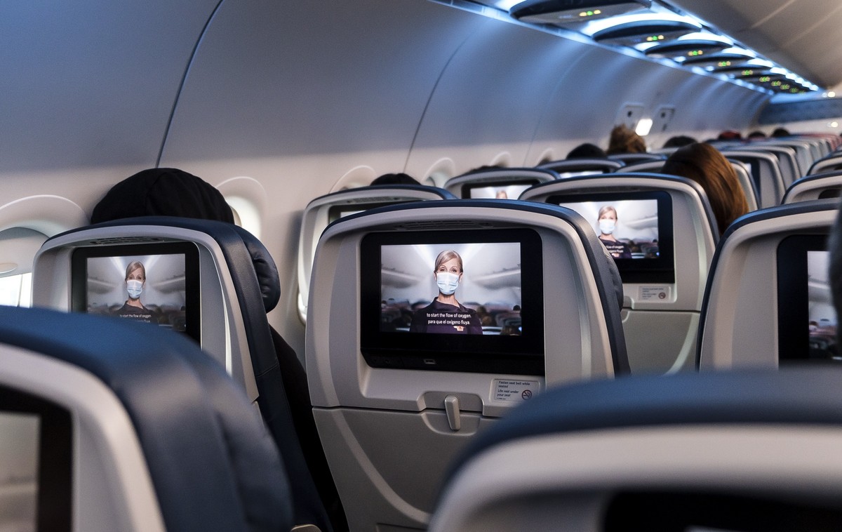 epa09112564 A safety video featuring a flight attendant in a mask is shown on an airplane in New York, New York, USA, 02 April 2021. The United States' airline industry reportedly lost 35 billion ...