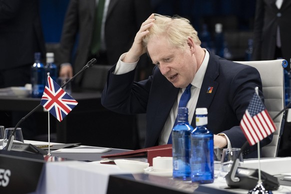 British Prime Minister Boris Johnson gestures at the start of the second plenary session of the NATO summit in Madrid, Wednesday, June 29, 2022. North Atlantic Treaty Organization heads of state will  ...