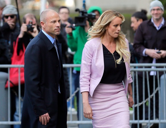 FILE - In this April 16, 2018 file photo, Stormy Daniels, right, and her attorney Michael Avenatti turn from the microphones after speaking as they leave federal court in New York. Avenatti, the trash ...
