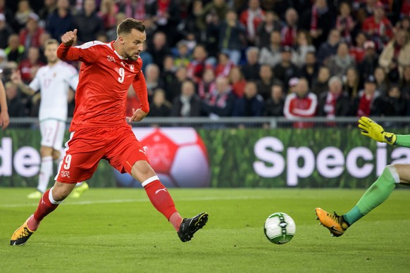 Switzerland&#039;s Haris Seferovic, left, fights for the ball against Hungary&#039;s goalkeeper Peter Gulacsi, right, during the 2018 Fifa World Cup Russia group B qualification soccer match between S ...