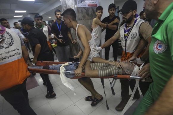 A wounded Palestinian is carried into the al-Shifa hospital following Israeli airstrikes on Gaza City, central Gaza Strip, Monday, Oct. 23, 2023. (AP Photo/Abed Khaled)