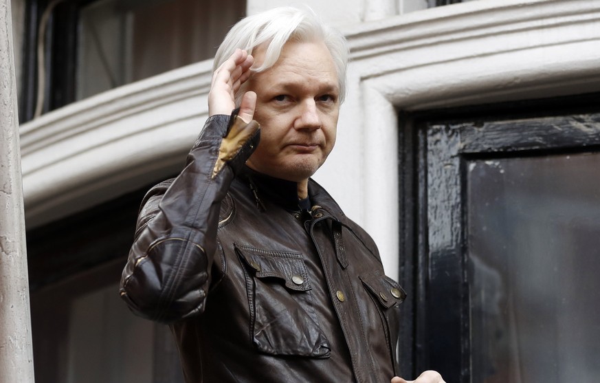 FILE - WikiLeaks founder Julian Assange greets supporters from a balcony of the Ecuadorian embassy in London, May 19, 2017. Britain