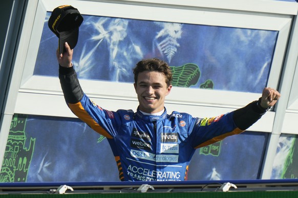 FILE - Mclaren driver Lando Norris of Britain celebrates his second place at the Italian Formula One Grand Prix, at Monza racetrack, in Monza, Italy, Sunday, Sept.12, 2021. Formula One team McLaren ha ...