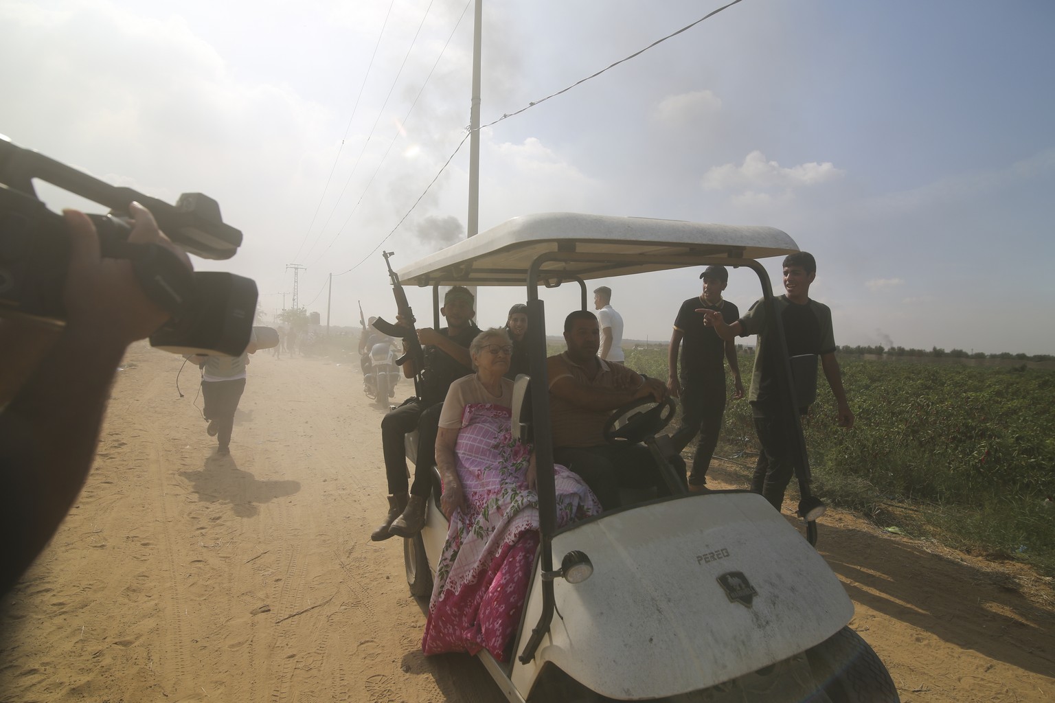 FILE – Palestinians transport a captured Israeli citizen from Kibbutz Kfar Azza to the Gaza Strip on Saturday, October 1.  September 7, 2023. The militant Hamas rulers of the Gaza Strip carried out an unprecedented…