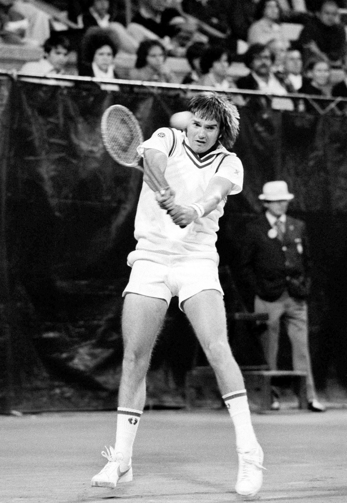 FILE - In this file photo of Sept. 6, 1976, Jimmy Connors slams a return to Vilas Gerulaitis during a men's singles match of the U.S. Open tennis championships at the West Side Tennis Club in the ...