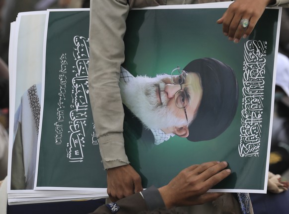 epa13191542 A vendor sells portraits of the late Iranian Supreme Leader Ayatollah?Ali?Khamenei during the Mawlid celebration, marking the Prophet Muhammad's birthday, in Sana'a, Yemen, 25 Au ...