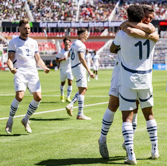 Switzerland&#039;s Dan Ndoye, center, celebrates after scoring the 1:3 goal with Switzerland&#039;s soccer players during a Friendly soccer match between Mexico and Switzerland at the Rice-Eccles Stad ...