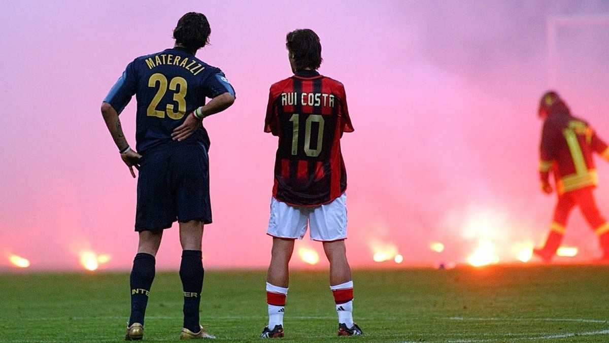 Inter Milan's Marco Materazzi, left, and AC Milan's Rui Costa look on as the match was stopped to clean up flares thrown by fans during their Champions League quarterfinal second leg match a ...