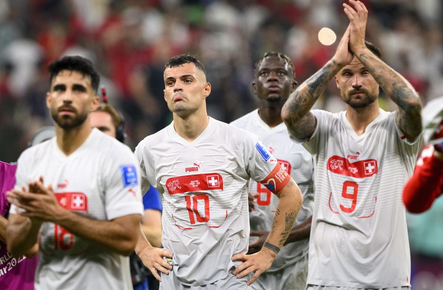 epa10353042 A dejected Granit Xhaka of Switzerland and teammates after the FIFA World Cup 2022 round of 16 soccer match between Portugal and Switzerland at Lusail Stadium in Lusail, Qatar, 06 December ...