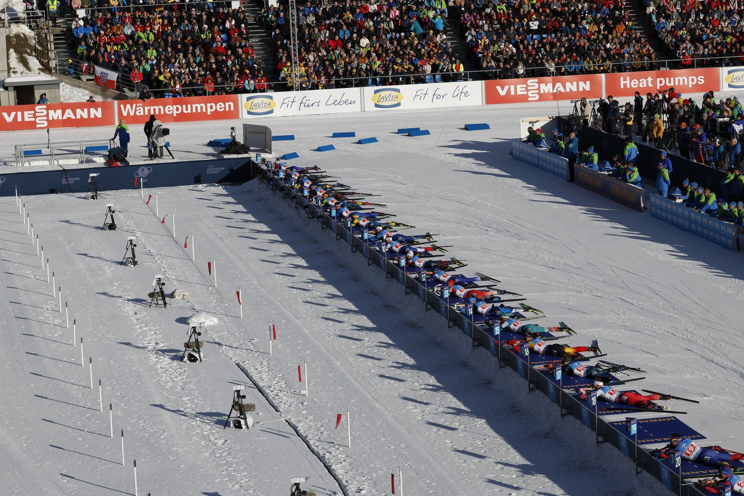 Athletes are seen at the shooting range during a Biathlon World Cup event at the Anterselva Biathlon Arena, venue for the biathlon discipline at the Milan Cortina 2026 Winter Olympics, in Anterselva,  ...