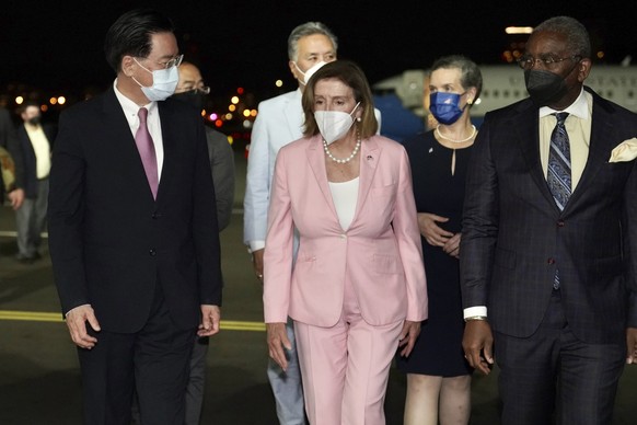 In this photo released by the Taiwan Ministry of Foreign Affairs, U.S. House Speaker Nancy Pelosi, center, walks with Taiwan&#039;s Foreign Minister Joseph Wu, left, as she arrives in Taipei, Taiwan,  ...