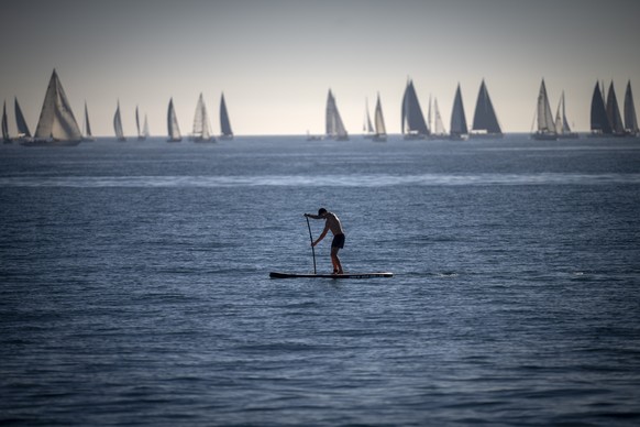 FILE - A man paddles in the Mediterranean Sea in Barcelona, Spain, Feb. 4, 2024. Earth has exceeded global heat records in February, according to the European Union climate agency Copernicus. (AP Phot ...