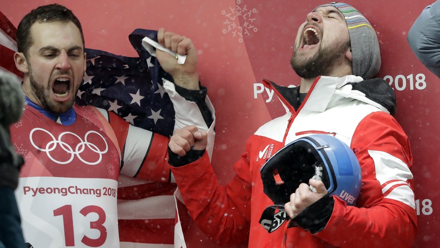 Chris Mazdzer of United States celebrates his silver medal win, left, as David Gleirscher of Austria celebrates his gold medal win during final heats of the men&#039;s luge competition at the 2018 Win ...