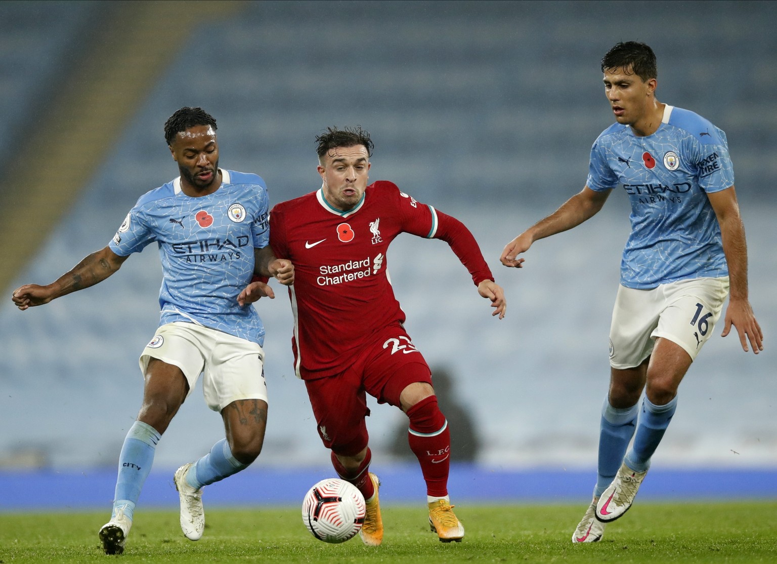 epa08808451 Liverpool&#039;s Xherdan Shaqiri (C) in action against Manchester City players Raheem Sterling (L) and Rodrigo (R) during the English Premier League soccer match between Manchester City an ...