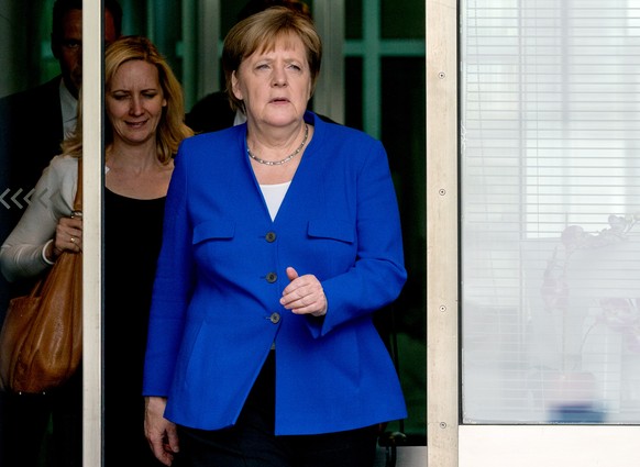 epa06857810 German Chancellor Angela Merkel of the Christian Democratic Union (CDU), leaves the Reichstag building, the seat of German Bundestag, in Berlin, Germany, 02 July 2018. The Christian Democr ...