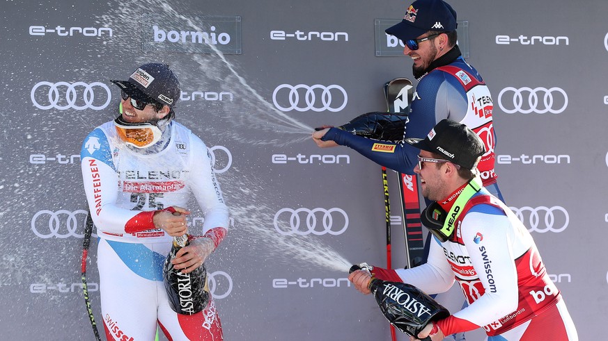 epa08092574 (L-R) Second placed Urs Kryenbuehl of Switzerland, winner Dominik Paris of Italy and third placed Beat Feuz of Switzerland celebrate on the podium after the Men&#039;s Downhill race at the ...