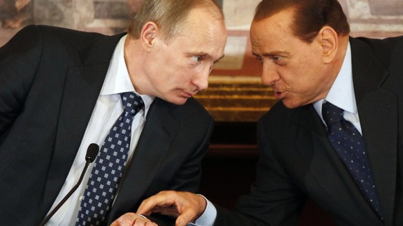 FILE -- In this April 26, 2010 file photo, then Italian Premier Silvio Berlusconi, right, and Russian President Vladimir Putin talk during a press conference at Villa Gernetto, in Gerno, near Milan, I ...