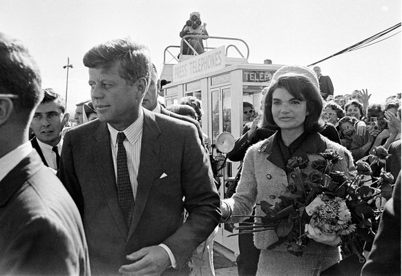 President John F. Kennedy and his wife Jacqueline Kennedy are greeted by an enthusiastic crowd upon their arrival at Dallas Love Field, on November 22, 1963. Only a few hours later the president was a ...
