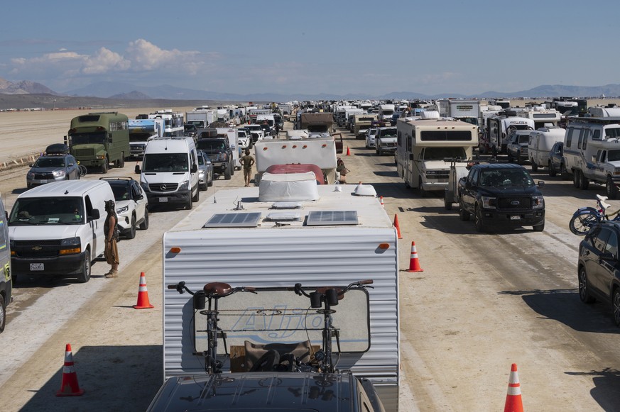 Vehicles line up to leave the Burning Man festival in Black Rock Desert, Nev., Tuesday, Sept. 5, 2023. The traffic jam leaving the festival eased up considerably Tuesday as the exodus from the mud-cak ...
