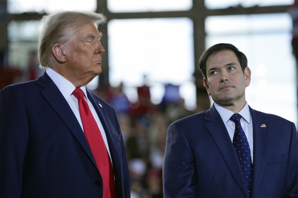 Republican presidential nominee former President Donald Trump speaks with Sen. Marco Rubio, R-Fla., during a campaign rally at J.S. Dorton Arena, Monday, Nov. 4, 2024, in Raleigh, N.C. (AP Photo/Evan  ...