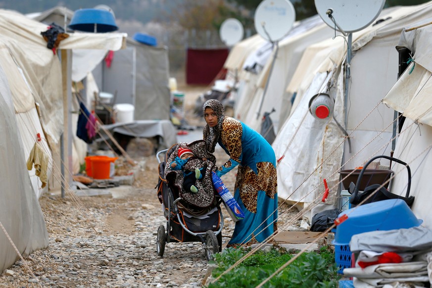 A Syrian refugee mother puts her baby to stroller in Nizip refugee camp, near the Turkish-Syrian border in Gaziantep province, Turkey, November 30, 2016. REUTERS/Umit Bektas