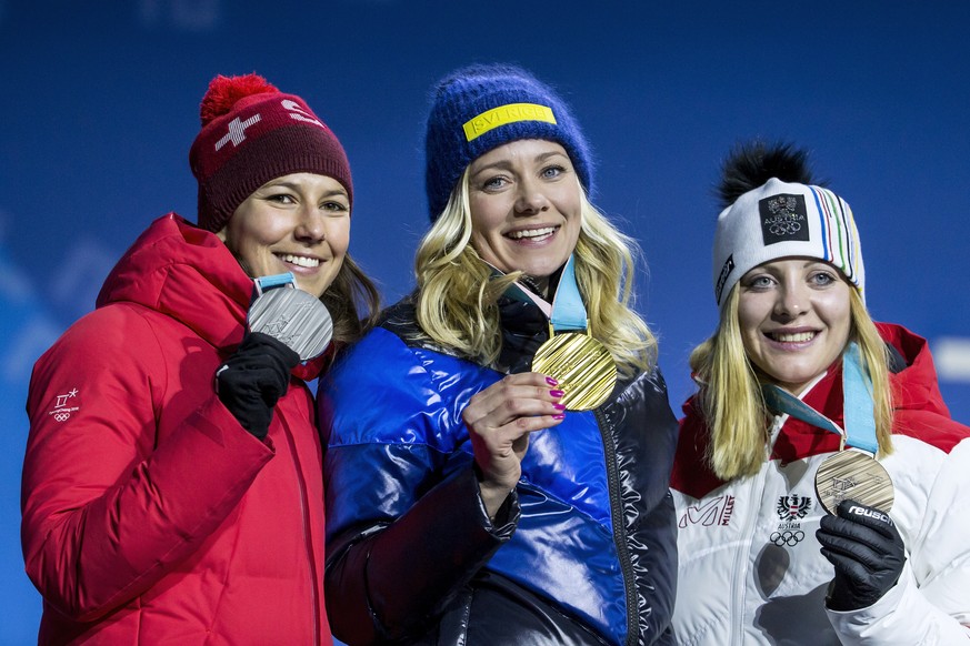 Silver medalist Wendy Holdener of Switzerland, Gold medalist Frida Hansdotter of Sweden, and Bronze medalist Katharina Gallhuber of Austria, from left, during the victory ceremony on the Medal Plaza f ...