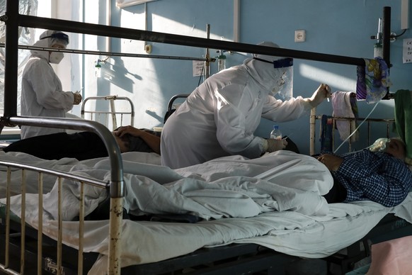 Medics wearing special suits to protect against coronavirus treat patients with coronavirus at an ICU of a hospital in Volgograd, Russia, Sunday, Nov. 21, 2021. The latest surge in deaths comes amid l ...