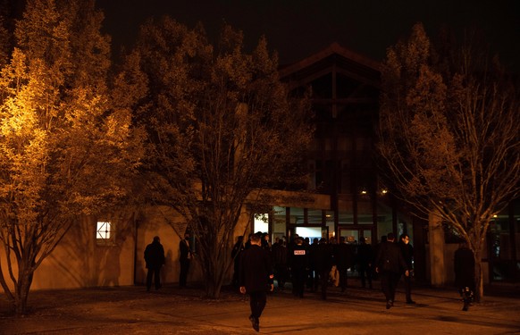 epa08751660 French police officers stand as French President Emmanuel Macron (not seen) leaves a middle school in Conflans Saint-Honorine, 30kms northwest of Paris, France, 16 October 2020 after a tea ...