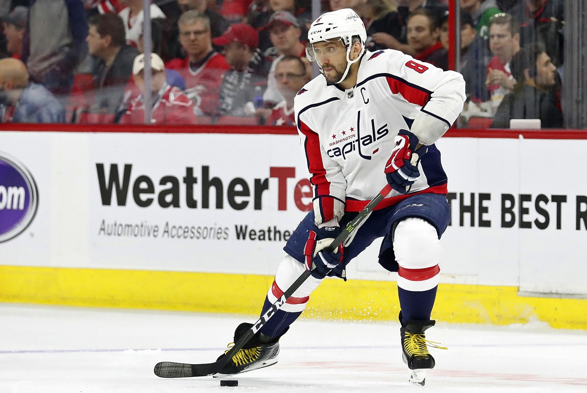 FILE - In this April 18, 2019, file photo, Washington Capitals' Alex Ovechkin (8) works the puck against the Carolina Hurricanes during the first period of Game 4 of an NHL hockey first-round pla ...