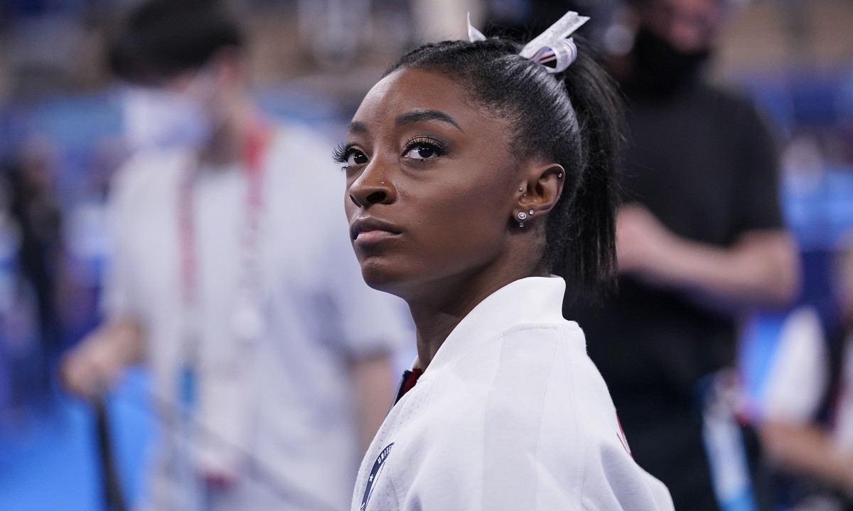 Simone Biles, of the United States, waits for her turn to perform during the artistic gymnastics women's final at the 2020 Summer Olympics, Tuesday, July 27, 2021, in Tokyo. (AP Photo/Gregory Bul ...