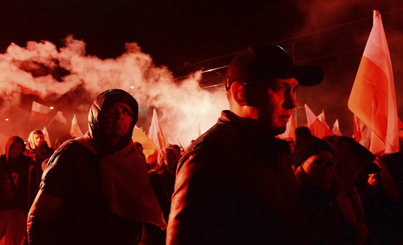 Marchers burn flares as they take part in the annual March of Independence organized by far right activists to celebrate 100 years of Poland&#039;s independence marking the nation regaining its sovere ...