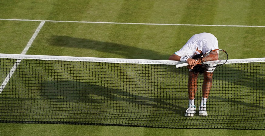 epa07695565 Marcos Baghdatis of Cyprus in action against Matteo Berrettini of Italy during their second round match at the Wimbledon Championships at the All England Lawn Tennis Club, in London, Brita ...