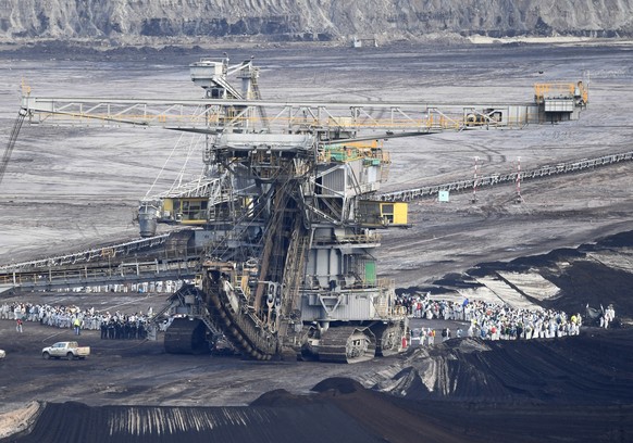 FILE-In this Nov. 24, 2019 file photo supporters of the climate movement Ende Gelaende protest at the coal-fired power station Lippendorf near Leipzig, Germany. The state governors Dietmar Woidke of B ...