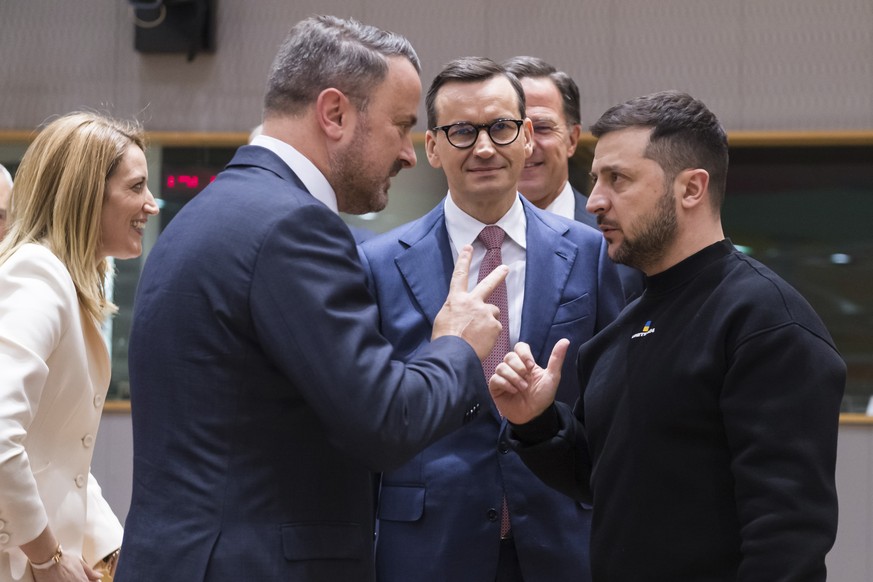 Luxembourg Prime Minister Xavier Bettel, left, and Polish Prime Minister Mateusz Morawiecki, center, speak with Ukrainian President Volodymyr Zelenskyy at a round table meeting at an EU summit...