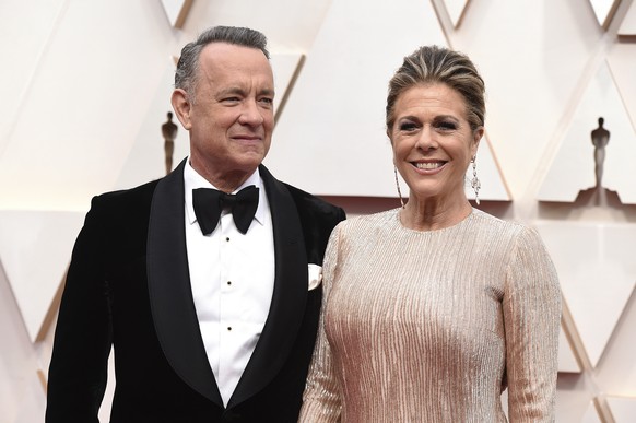 FILE - In this Feb. 9, 2020 file photo, Tom Hanks, left, and Rita Wilson arrive at the Oscars at the Dolby Theatre in Los Angeles. The couple have tested positive for the coronavirus, the actor said i ...