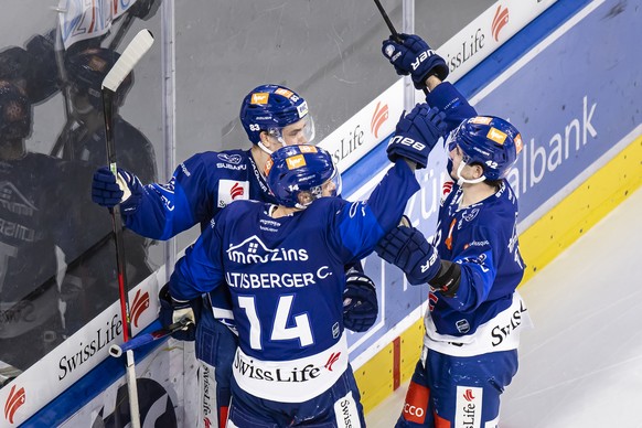 Zuerichs, Chris Baltisberger, Mitte, jubelt mit Juho Lammikko, links, und Alexandre Texier, rechts, nach seinem Tor zum 5:3 im Eishockeyspiel der National League zwischen den ZSC Lions und dem Genf Se ...