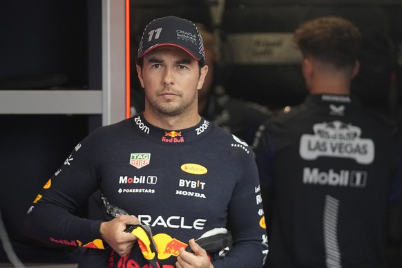 Red Bull driver Sergio Perez, of Mexico, waits in the garage before the first practice session for the Formula One Las Vegas Grand Prix auto race, Thursday, Nov. 16, 2023, in Las Vegas. (AP Photo/Darr ...