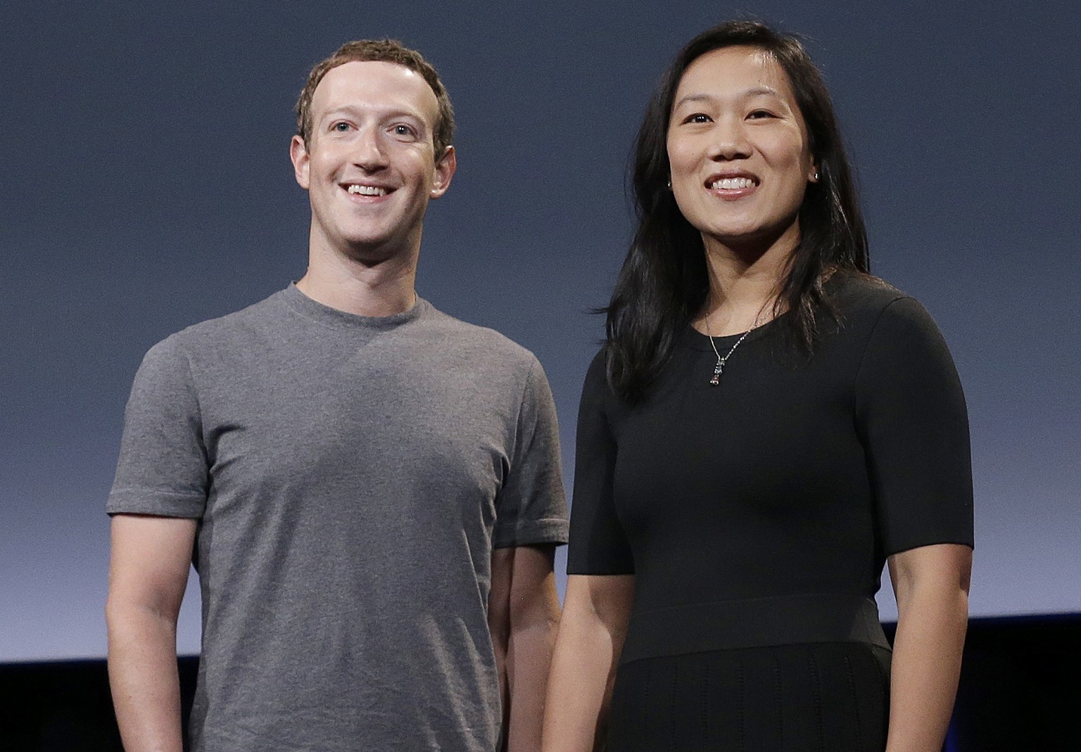 FILE - In this Sept. 20, 2016 file photo, Facebook CEO Mark Zuckerberg and his wife, Priscilla Chan, smile as they prepare for a speech in San Francisco. Zuckerberg and his wife are expecting their se ...