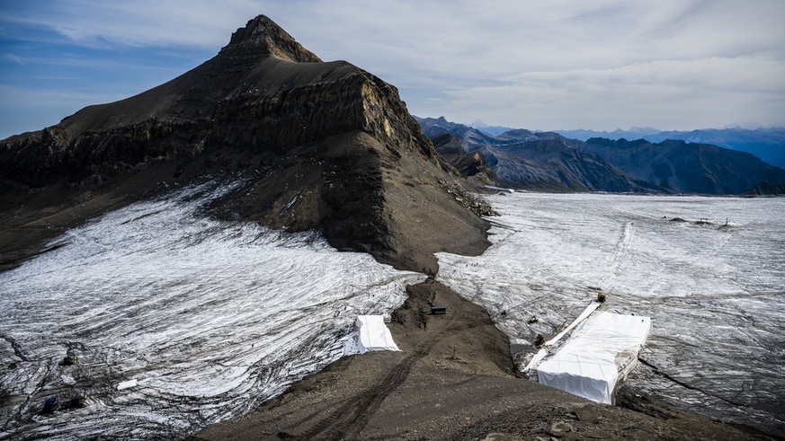 Hikers walk along the separation of the Scex Rouge Glacier from the Tsanfleuron Glacier in the Glacier 3000 area above Les Diablerets on Tuesday, September 13, 2022, making...