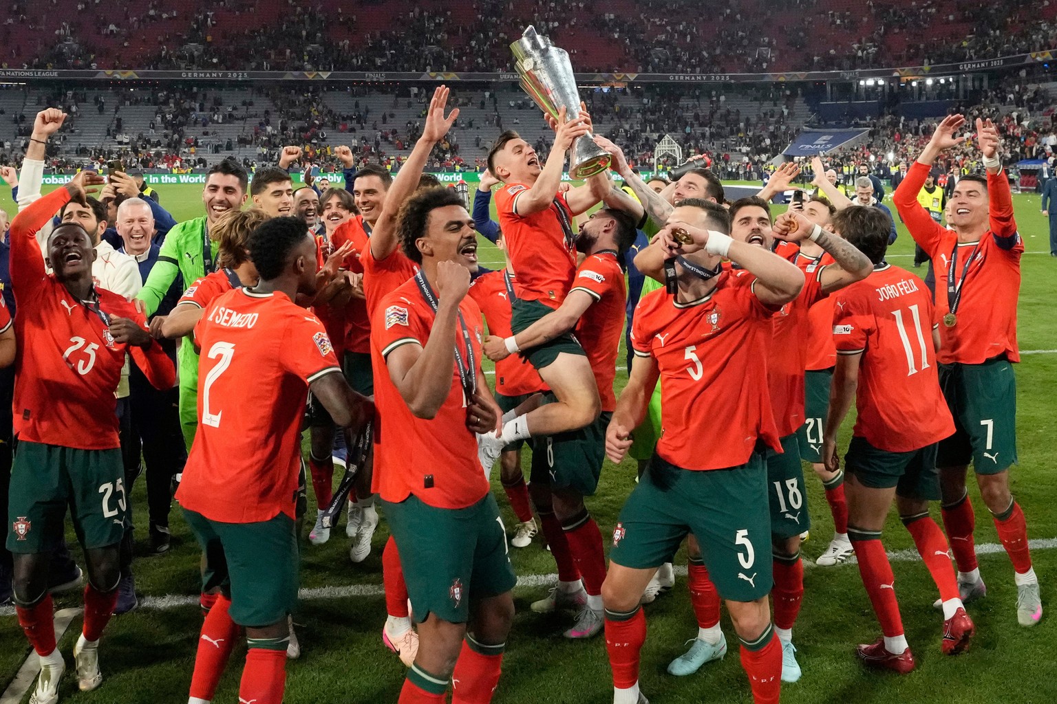 FILE - Portugal's players celebrate with the trophy after winning the Nations League soccer championship at the Allianz Arena in Munich, Germany, June 8, 2025. (AP Photo/Martin Meissner, File)
Po ...