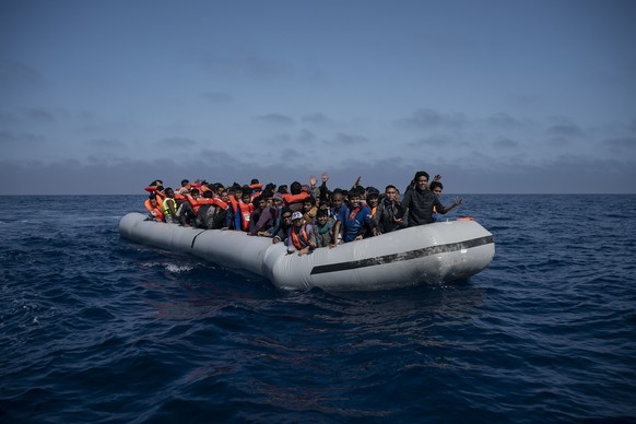 FILE - In this Sunday, May 6, 2018 file photo refugees and migrants wait to be rescued by members of the Spanish NGO Proactiva Open Arms, after leaving Libya trying to reach European soil aboard an ov ...