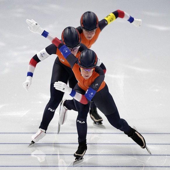 Team Netherlands, led by Ireen Wust, with Antoinette De Jong center and Irene Schouten behind, competes in the speedskating women&#039;s team pursuit quarterfinals at the 2022 Winter Olympics, Saturda ...