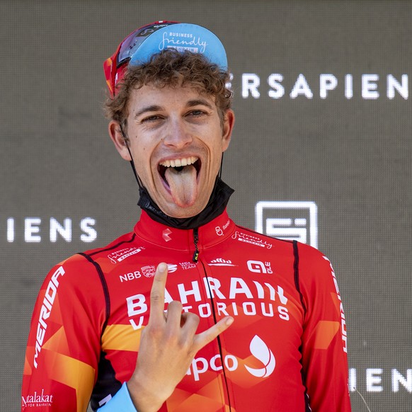 epa09267667 Gino Maeder from Switzerland of Bahrain Victorious reacts on the podium after the eigth and final stage, a 160 km race with start and finish in Andermatt, at the 84th Tour de Suisse UCI Pr ...