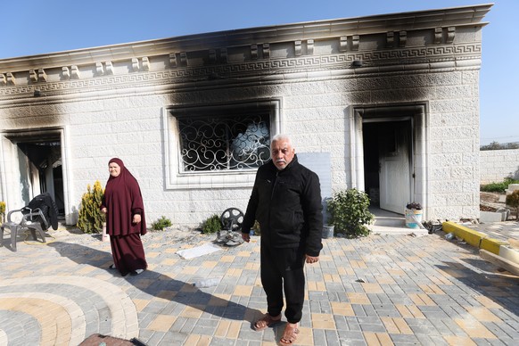 epa10493469 Palestinians show the damage to a building after a shooting the day before that killed two Israelis, near the West Bank town of Nablus, Feb. 27, 2023. A Palestine ...