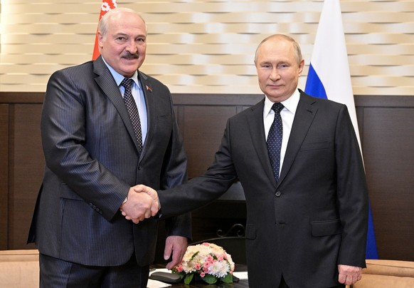 Russian President Vladimir Putin, right, and Belarusian President Alexander Lukashenko shake hands during their meeting at the Bocharov Ruchei residence in the Black Sea resort of Sochi, Russia, Monda ...