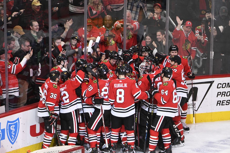 The Chicago Blackhawks celebrate Chicago Blackhawks right wing Patrick Kane (88) 1,000th point on an assist against the Winnipeg Jets during the third period of an NHL hockey game Sunday, Jan. 19, 202 ...