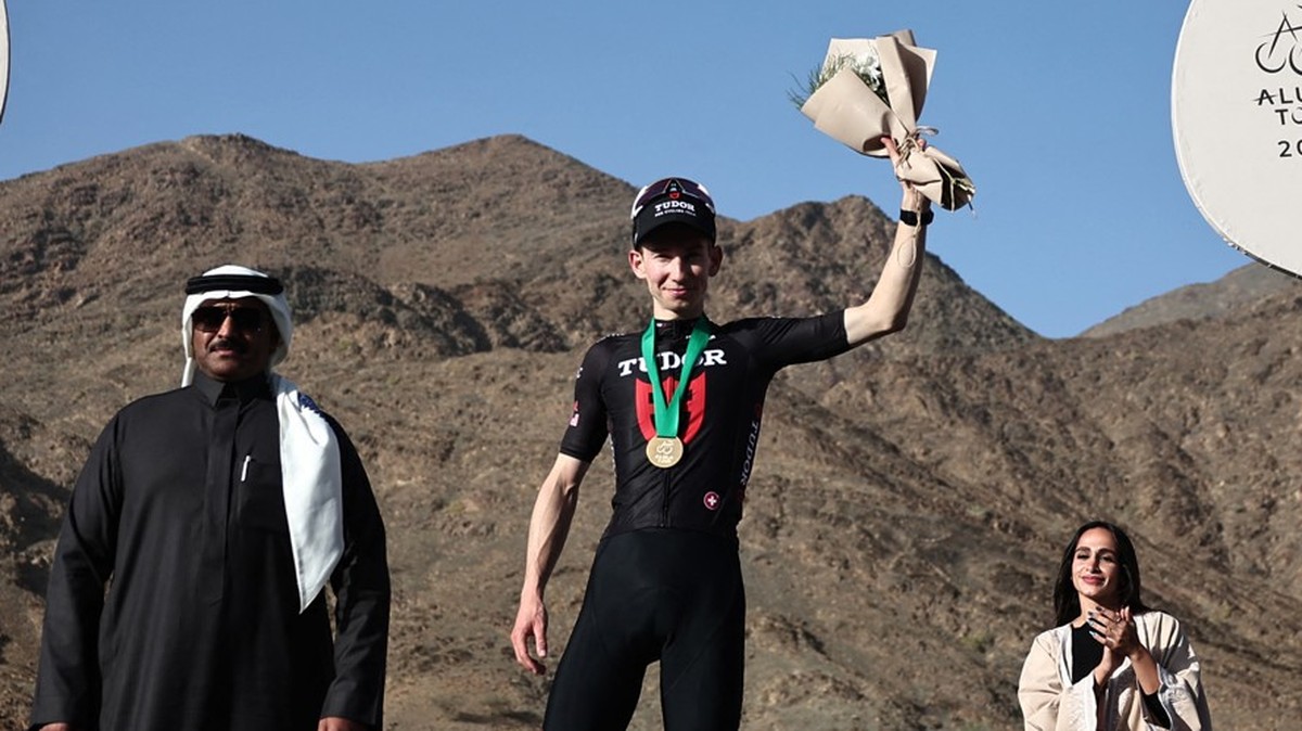 Tudor Pro Cycling Team's Swiss rider Yannis Voisard celebrates on the podium after winning the third stage of the AlUla Tour cycling race, 142.1km from Winter Park to Bir Jaydah Mountain Wirkah o ...