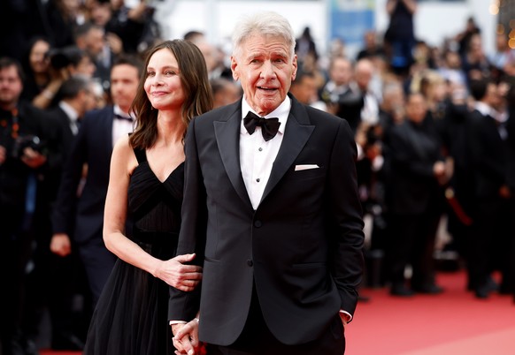 epa10637251 Harrison Ford (R) and Calista Flockhart arrive for the screening of &#039;Indiana Jones and the Dial of Destiny&#039; during the 76th annual Cannes Film Festival, in Cannes, France, 18 May ...
