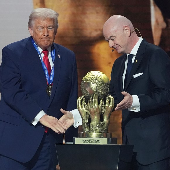FILE - FIFA President Gianni Infantino presents President Donald Trump with the FIFA Peace Prize during the draw for the 2026 soccer World Cup at the Kennedy Center in Washington, Friday, Dec. 5, 2025 ...